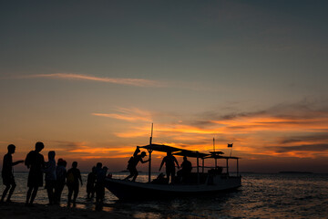Boat trip during beautiful sunset over tropical Indonesian Island Karimunjava. 