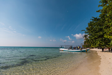 Boat trip on a tropical Indonesian island Karimunjava with jungle and turquoise lagoon in the distance. 