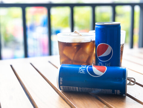 BANGKOK-THAILAND-MAY-29-2022 :  Pepsi Cola softdrink can and a glass of Pepsi, a carbonated soft drink produced and manufactured by Pepsi in thailand