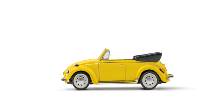 Model of yellow retro toy car cabriolet on white background. Miniature car side view with copy space