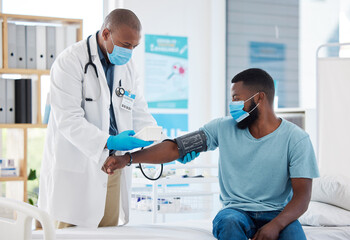 Doctor, covid and blood pressure with black man patient for heart health, test or examination....