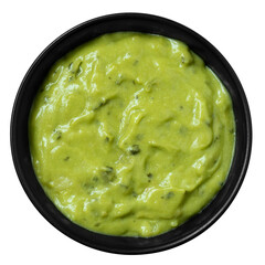 Guacamole dip in a black ceramic bowl isolated from above.