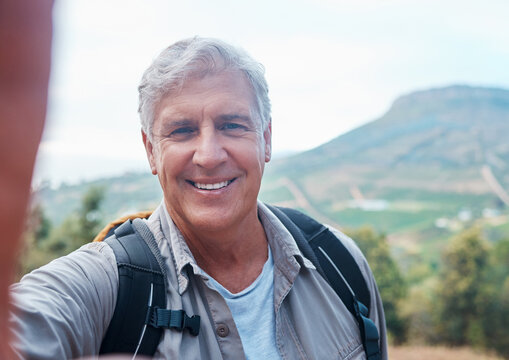 Selfie, hiking and portrait of old man on mountain for outdoor adventure, freedom and wellness in nature. Retirement, traveling and happy senior male take picture on hike, trekking and summer holiday