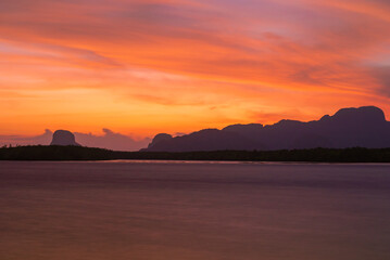 red sky sunset and river or lake