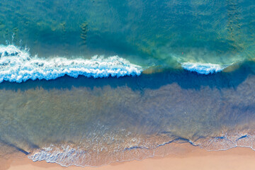(Top view) Aerial view drone over beach sea. Beautiful sea waves. Beach sand and amazing sea. Summer sunset seascape. Phuket Thailand Beach. Water texture. Top view of the fantastic natural sunsets