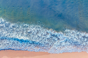 (Top view) Aerial view drone over beach sea. Beautiful sea waves. Beach sand and amazing sea. Summer sunset seascape. Phuket Thailand Beach. Water texture. Top view of the fantastic natural sunsets