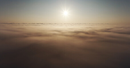 Aerial drone view sunrise over the sea of fog