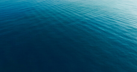 Top- view blue seawater texture, Sunshine Refection on blue water wave texture background.