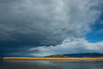 A thunderstorm is brewing over the lake
