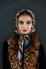 A woman in a leopard fur coat and a scarf