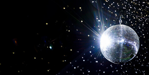 Captivating image of an illuminated disco ball casting a spray of light specks around the room. - obrazy, fototapety, plakaty