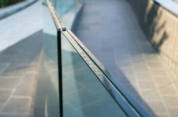 Closeup frameless laminated glass railing modern style.