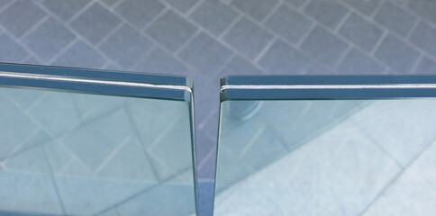 Closeup top view frameless laminated glass railing.