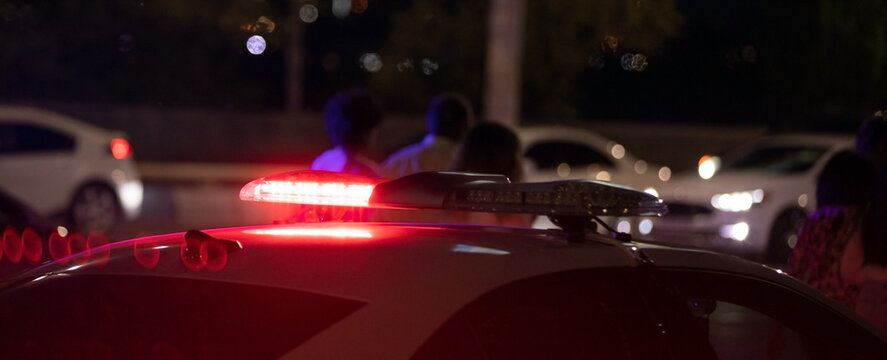 Red Light Flasher. Police Car At Night Time In The City