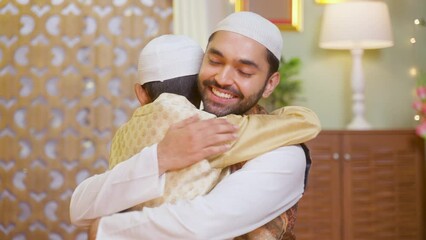Happy Muslim father with kid hugging each other while saying ramadan feast wishes at home
