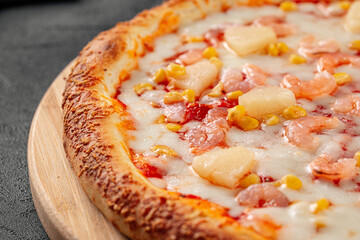 Portion of fresh hawaii pizza with pineapple and ham