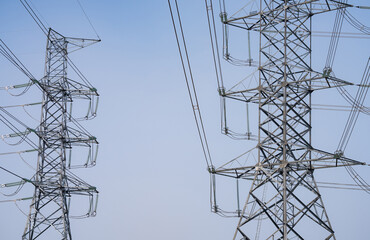 High voltage electric transmission tower. High voltage power lines against the sky. Electricity...