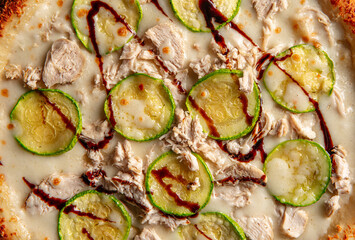 Closeup on chicken pizza with zucchini and balsamic sauce