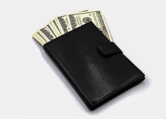 Black wallet with hundred dollar bills isolated on white background
