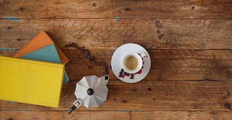 Foto auf Leinwand books with espresso coffee, cup and coffee pot, flat lay, reading relaxation, indulgence concept © Kirsten Hinte