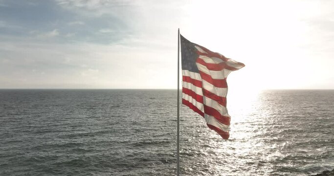 American Flag Waving. American Flag Near Sea Beach. National American Celebration, Labor Day, Independence Day, Flag Day, Memorial, Veterans, Patriots, President Day.