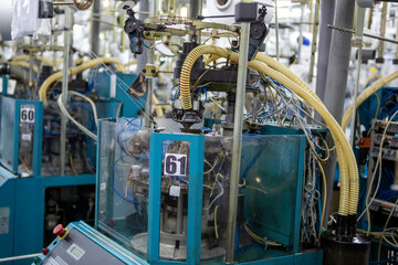 Textile industry with knitting machines in factory. Textile industry with a loom on the production of kapron tights.