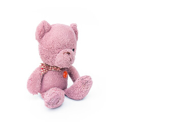 A broken and shabby old pink teddy bear isolated on white background and copy space.