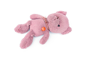 A broken and shabby old pink teddy bear isolated on white background.