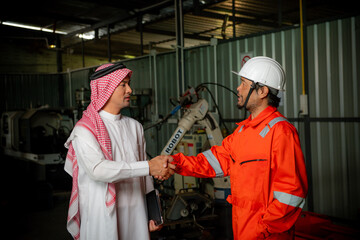 Cyber communication and robotic trend , Industrial 4.0 Cyber Physical Systems technology concept. Double exposure of business men handshake teamwork , welding automate robot arm in smart factory