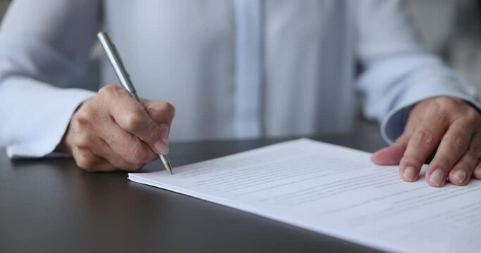 Close-up unknown middle aged business woman signing job contract, make successful purchase or investment deal, filling out legal document or form, signing an employment agreement after an interview