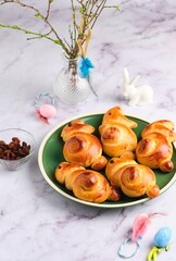 Easter bunny buns cooking step by step on a light background.