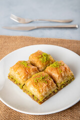 Pistachio Turkish baklava on a white plate,top view