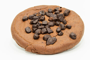 A gluten-free cocoa cookie with chocolate chips on a white background