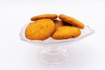 oatmeal cookies on a crystal platter on a white background.