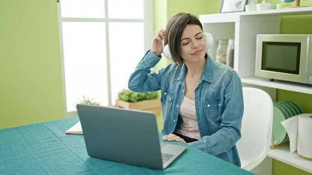 Young caucasian woman using laptop with winner expression at home