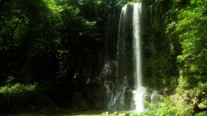 Kawasan Falls in green forest. Waterfall in the tropical mountain jungle. Bohol, Philippines.