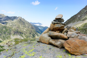 small cairn indicating the hiking trail in the Pyrenees. Small pile of pebbles indicating a milestone on a path in the mountains
