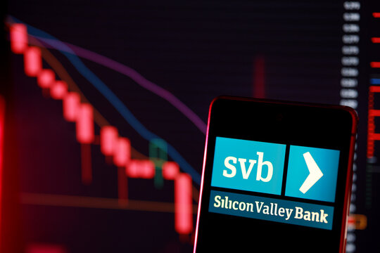 PENANG, MALAYSIA - 1 APR 2023: Silicon Valley Bank logo with stock market chart. The bank was shut down after its investments greatly decreased in value and depositors withdrew large amounts of money.