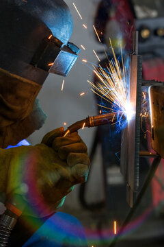 The welder is welding a structural steel with gas metal arc welding ( GMAW ) in the workshop.	