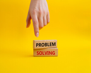 Problem solving symbol. Concept word Problem solving on wooden blocks. Businessman hand. Beautiful yellow background. Business and concept. Copy space