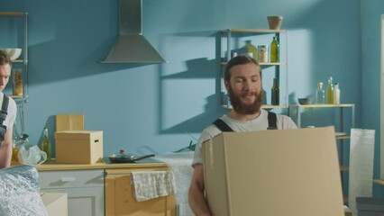 Workers of Moving Company With Uniforms Carefully Carrying Boxes. Team of Employee Workers Helps Customers to Relocation. Local Moving Services