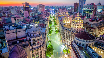 Buenos Aires Argentina Urban City Center at Night, Obelisk and Central Avenue during Summer, Orange and Violet Horizon Skyline drone aerial view  - obrazy, fototapety, plakaty