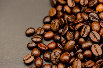 Espresso roasted coffee beans isolated in black background close up
