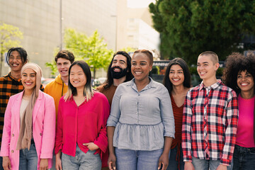 Happy diverse young people having fun together in the city smiling in front of camera - Concept of multiracial friendship