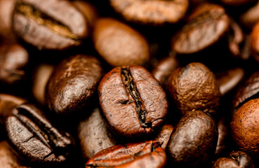 Espresso roasted coffee beans isolated in black background close up