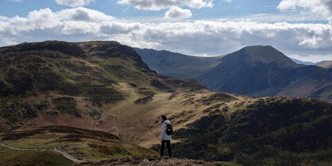 Person hiking in the mountains of Lake District, England.