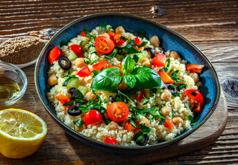 A plate of couscous served with vegetables and chickpeas