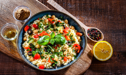 A plate of couscous served with vegetables and chickpeas