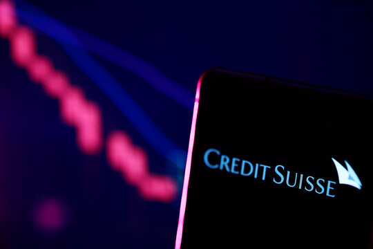 PENANG, MALAYSIA - 1 APR 2023: Credit Suisse Bank logo with stock market chart. Credit Suisse, the 2nd largest bank in Switzerland collapsed in March 2023 and was bought by rival UBS for 3 billion CHF