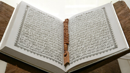 Fototapeta premium Conceptual image of religion. Holy tasbih or islamic prayer beads and Quran. Ramadan theme background